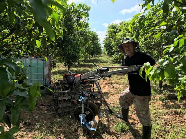 Preparing the tractor to spray the mango trees.